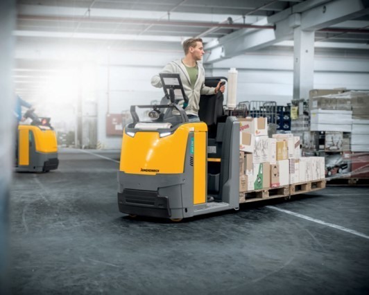 Semi-automated Jungheinrich pallet truck moving with operator