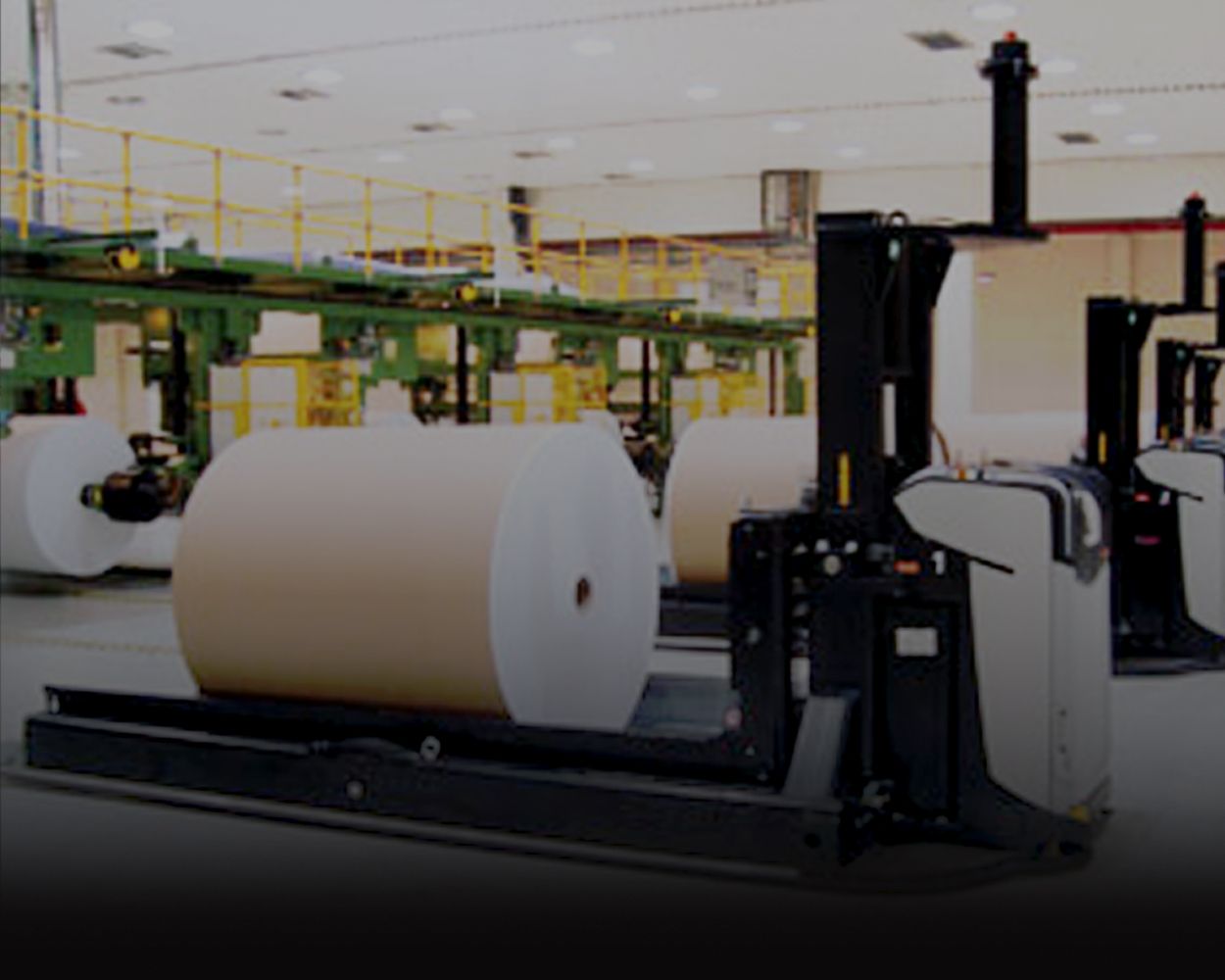 Automated guided vehicles featuring paper, bale and reel attachments